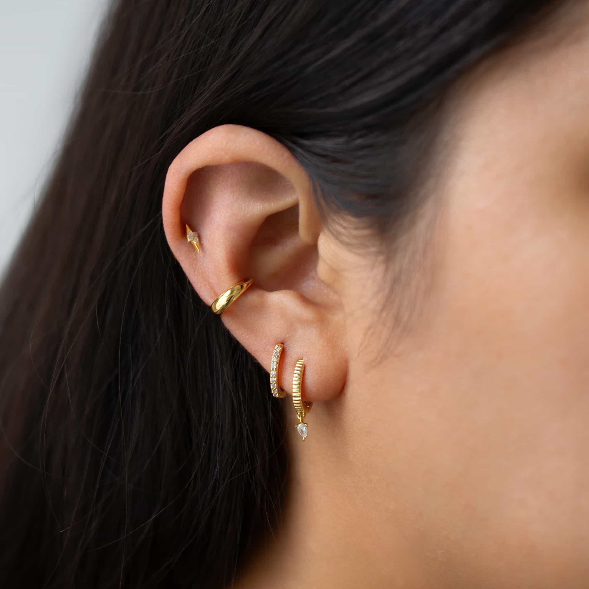Gold vermeil pavé white zirconia lightning bolt flat back stud worn in a model's upper ear