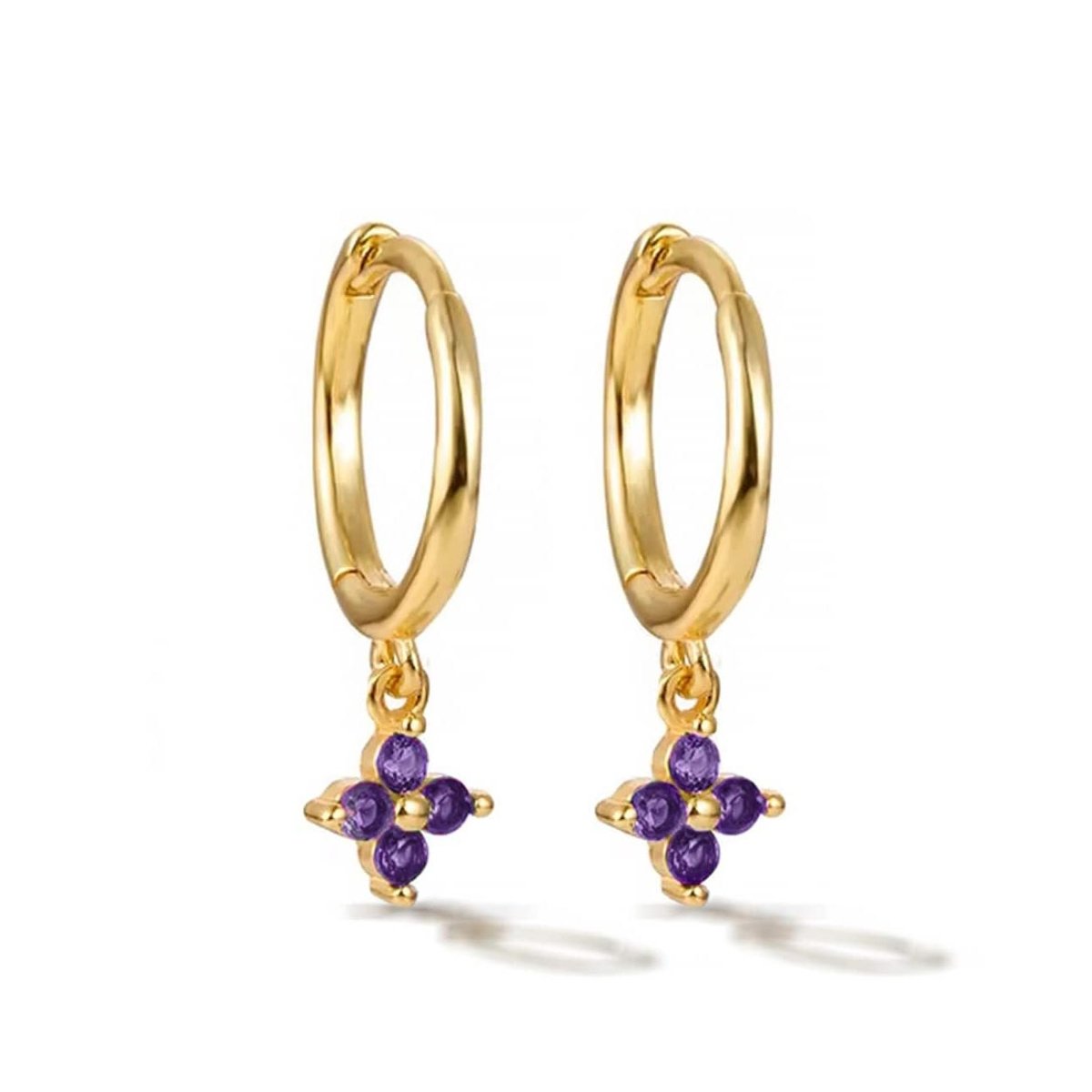 Pair of gold vermeil Flor huggie hoops with a purple amethyst four-stone flower, on a white background