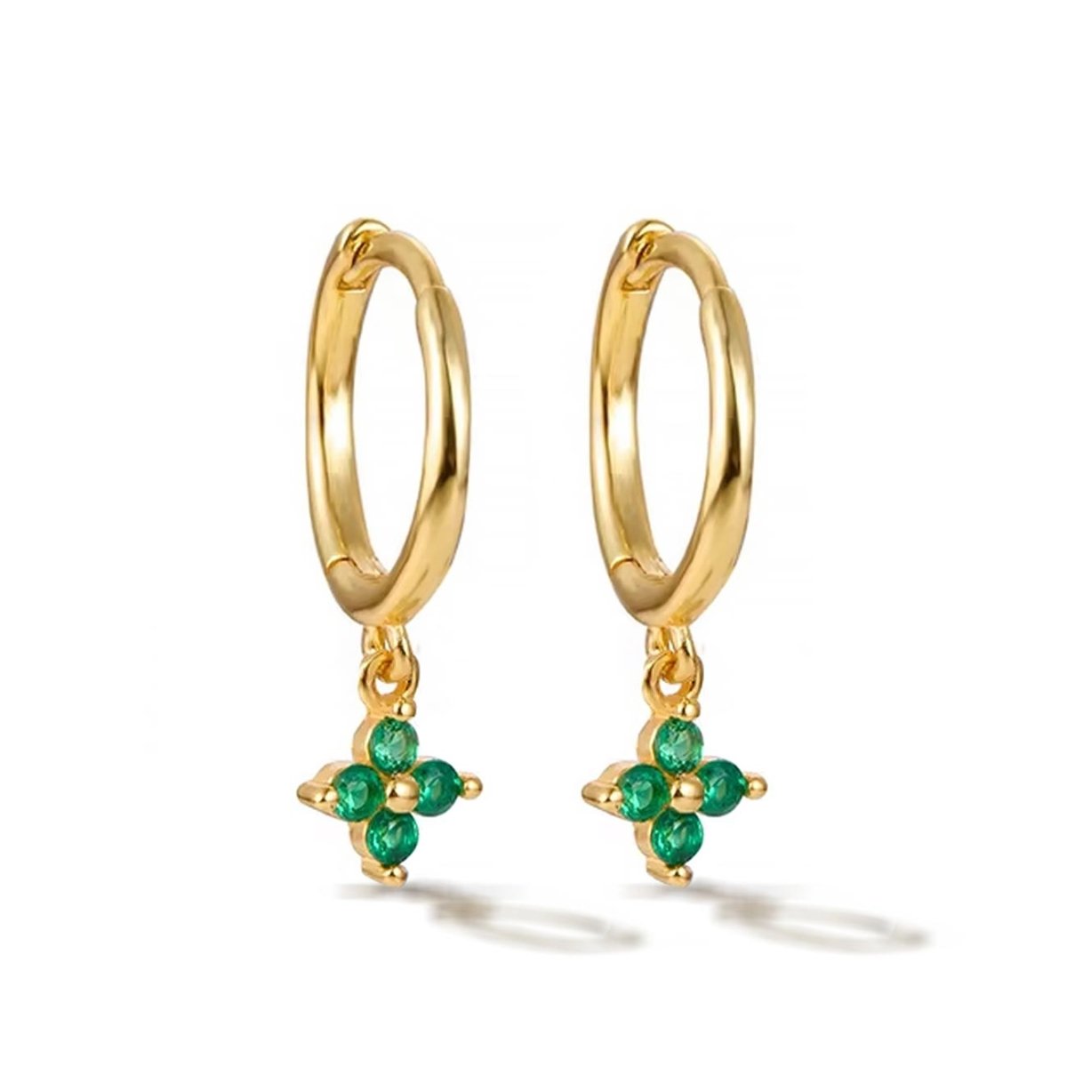 Pair of gold vermeil Flor huggie hoops with a green emerald four-stone flower, on a white background
