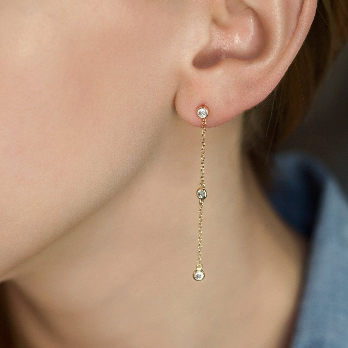 Gold vermeil white zirconia drop earring shown on a model's lobe