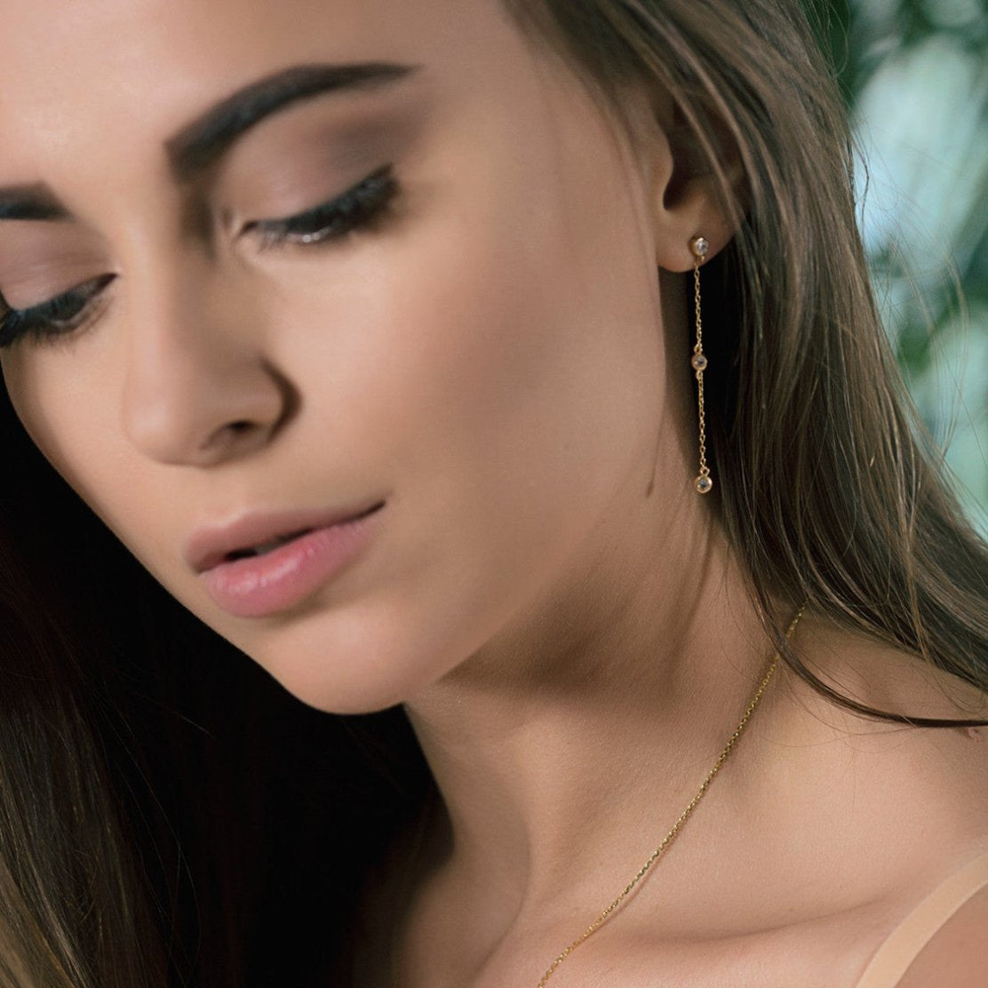 Sterling silver white zirconia drop earring shown on a model's lobe