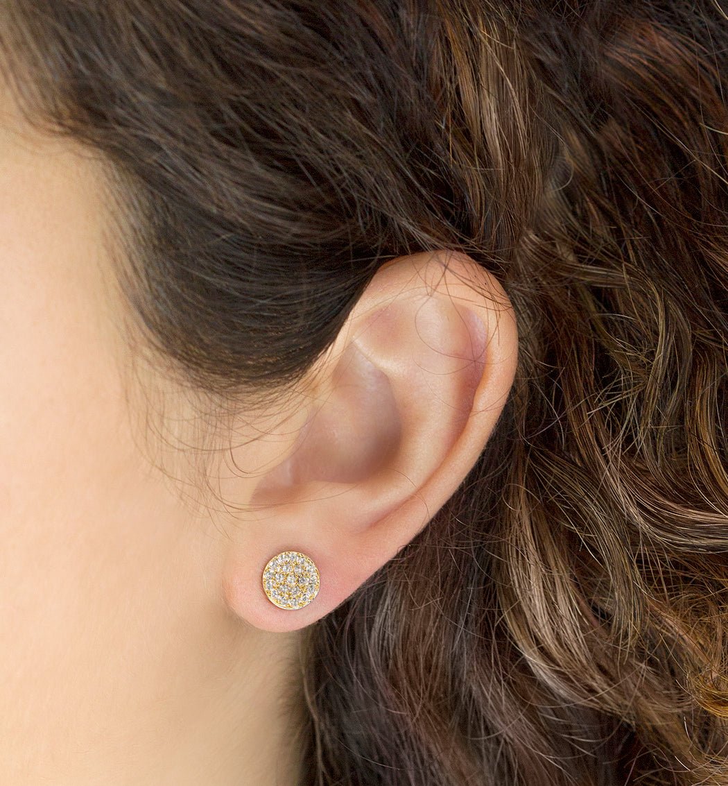 Gold vermeil pavé round stud with white zirconia, shown on a model's lobe