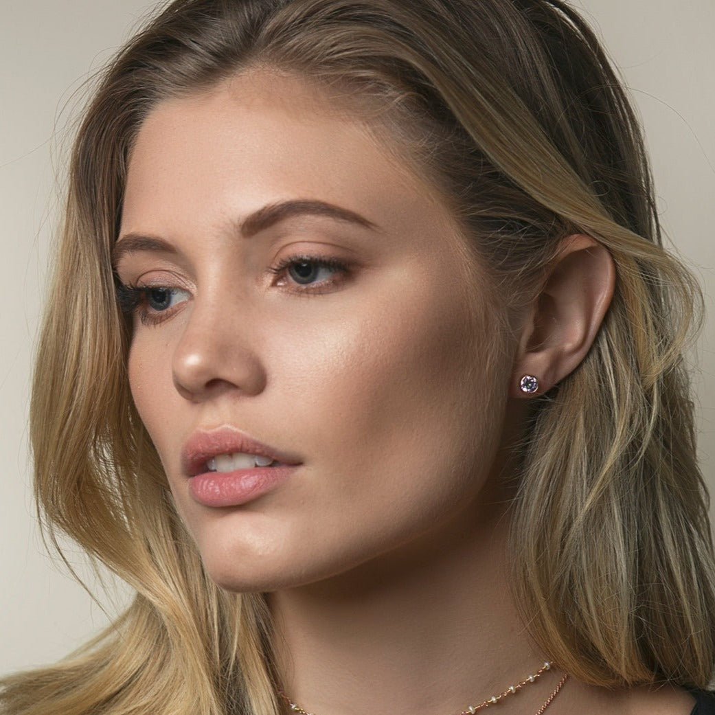 Rose gold vermeil round white zirconia stud earring shown on a model's lobe