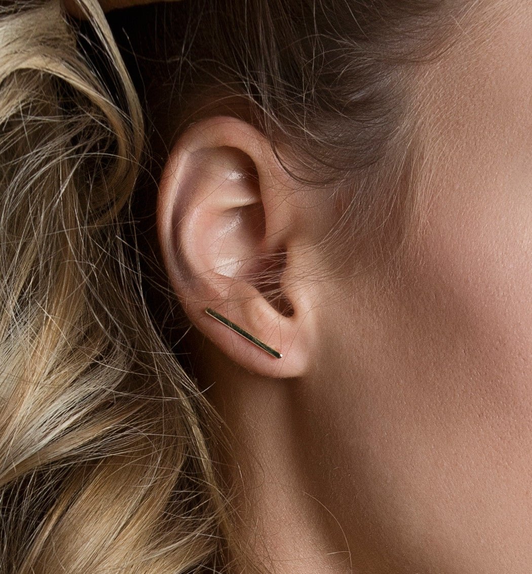 Rose gold vermeil bar ear climber along the lobe, shown on a model curving toward the helix