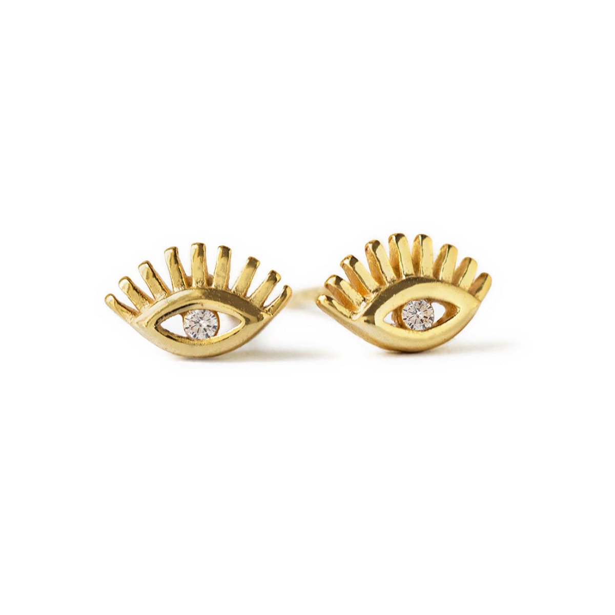Gold vermeil evil eye stud earrings with a clear center stone, on a white background