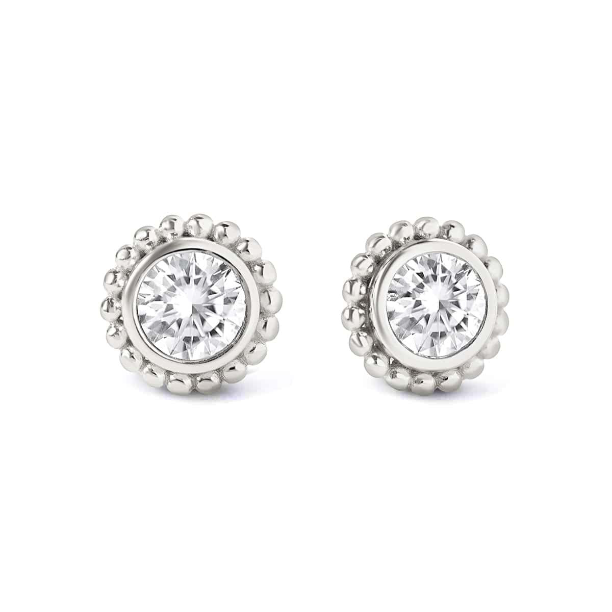 Pair of sterling silver studs with a round clear stone in a beaded halo, on a white background