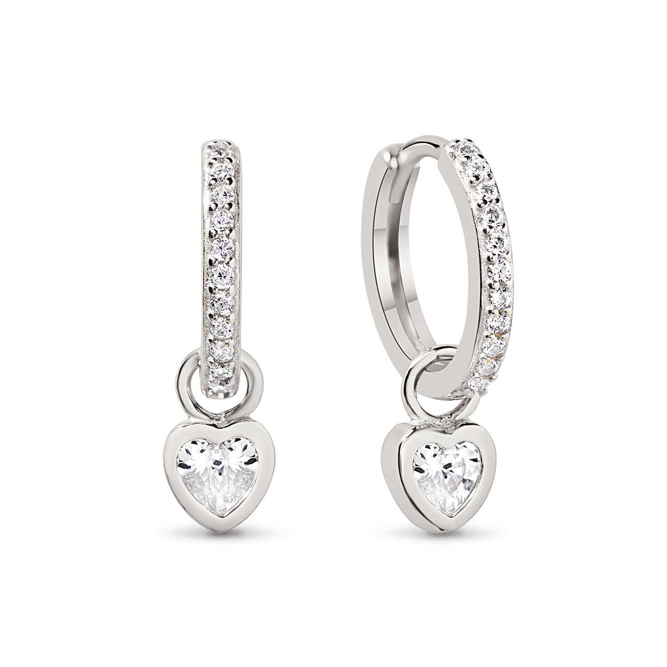 Sterling silver pavé huggie hoops with clear heart charms, close-up detail on a white background