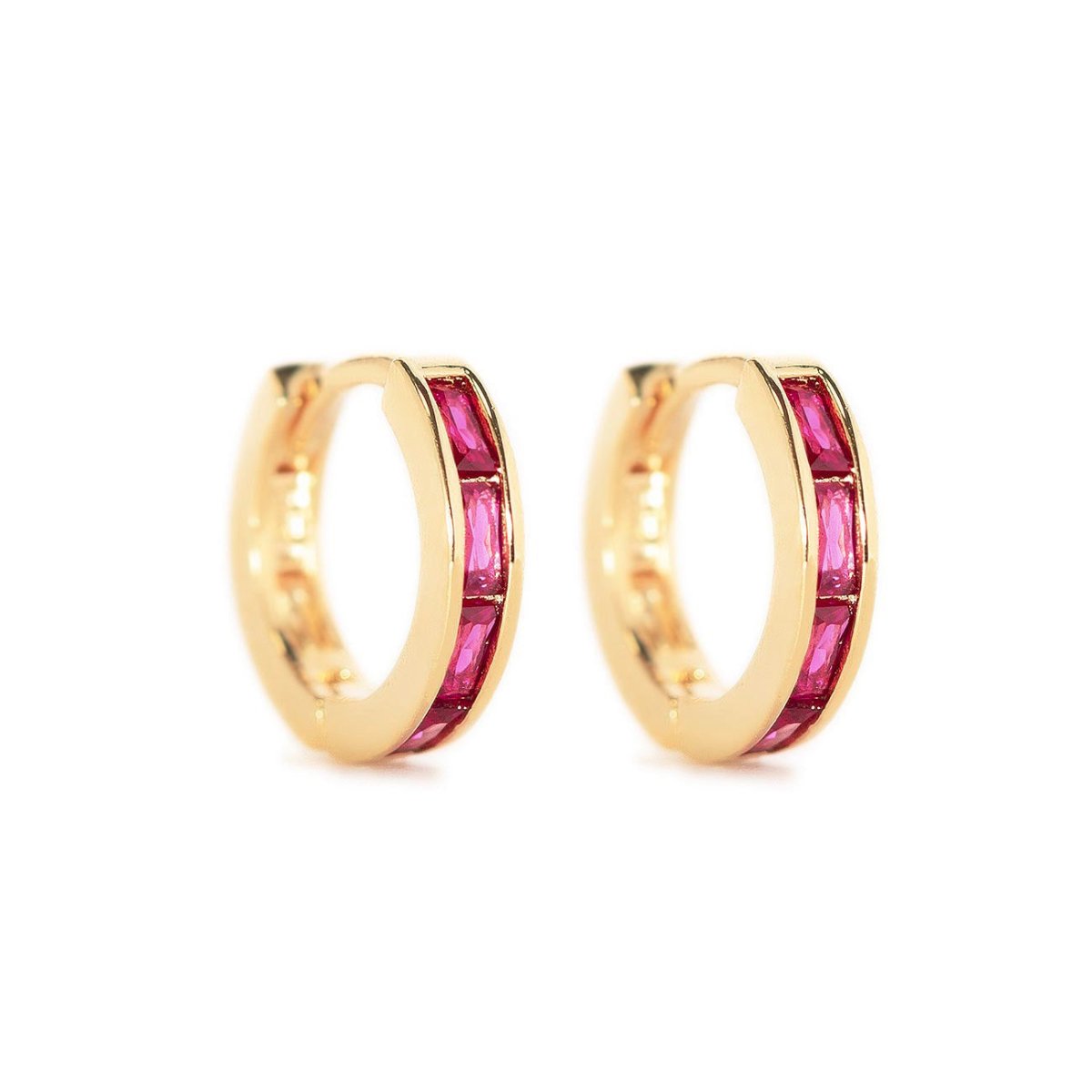 Gold vermeil huggie hoops with channel-set red baguette stones, shown as a pair on a white background