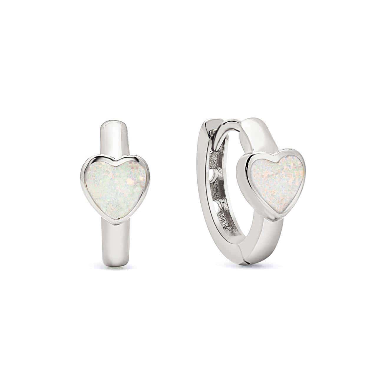 Sterling silver huggie hoops with white opal heart inlays, on a white background