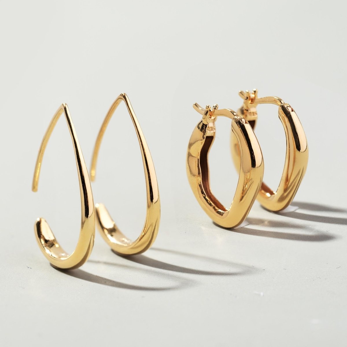 Gold vermeil teardrop hoop earrings, front and clasp views shown together on a light surface