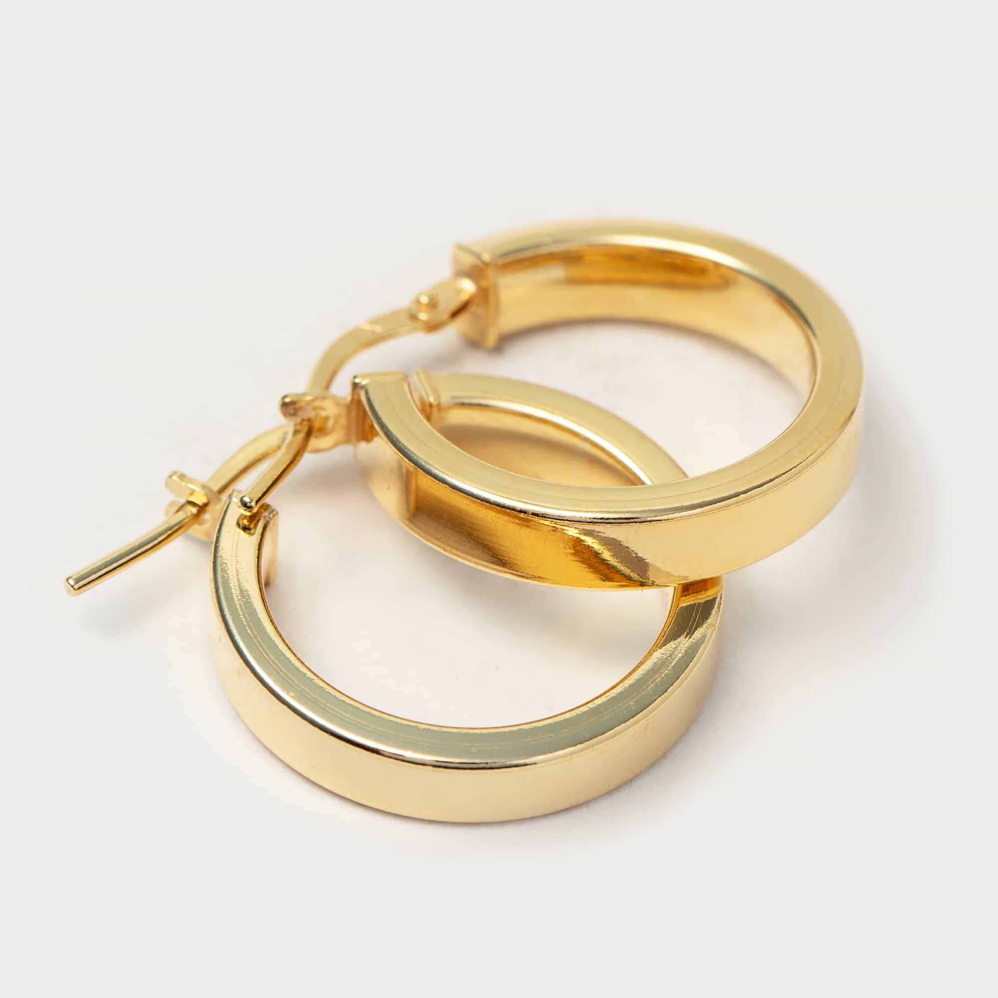 Gold vermeil flat block hoop earrings shown lying angled on a white background