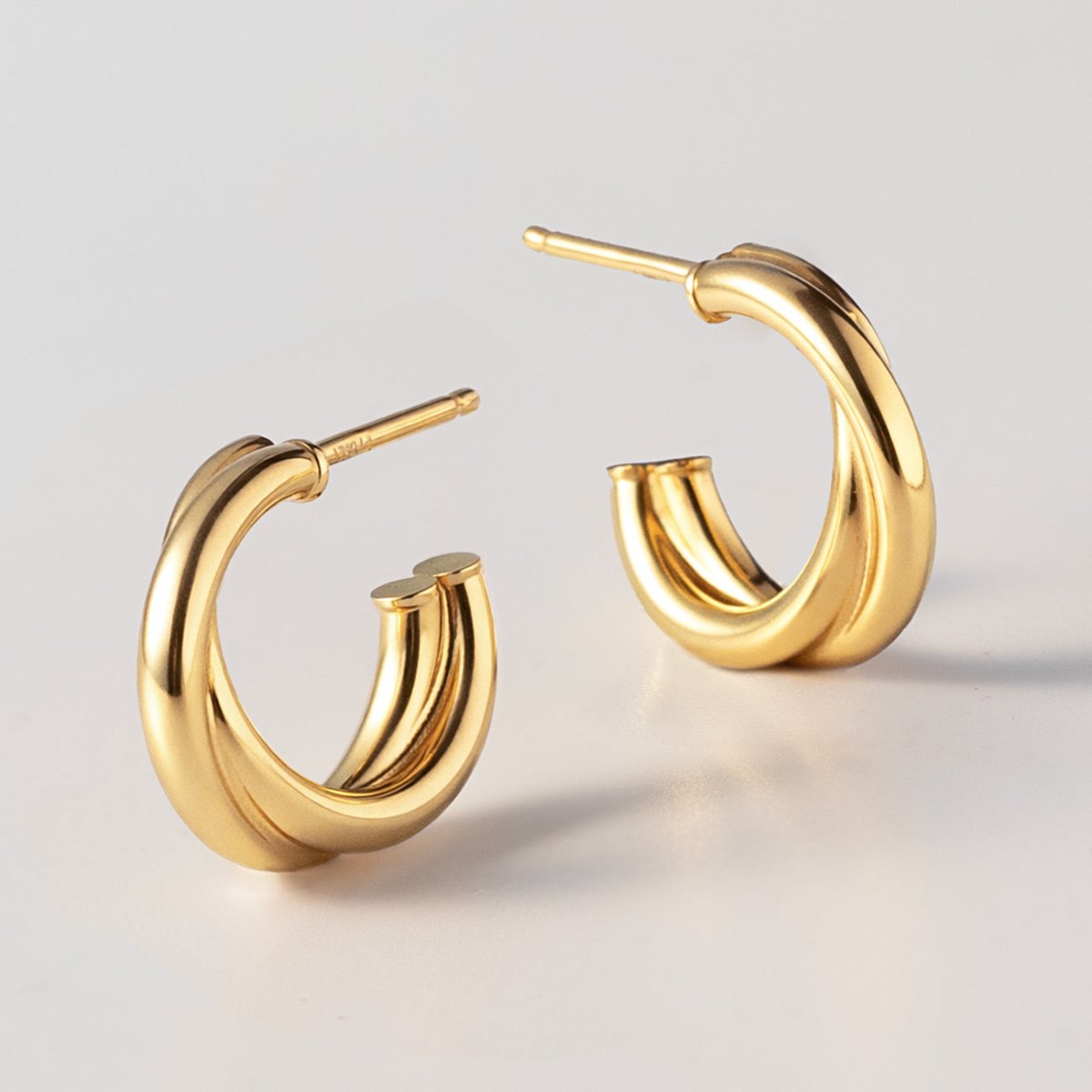 Gold vermeil criss cross mini hoops, close-up detail of the crossover bands on a white background