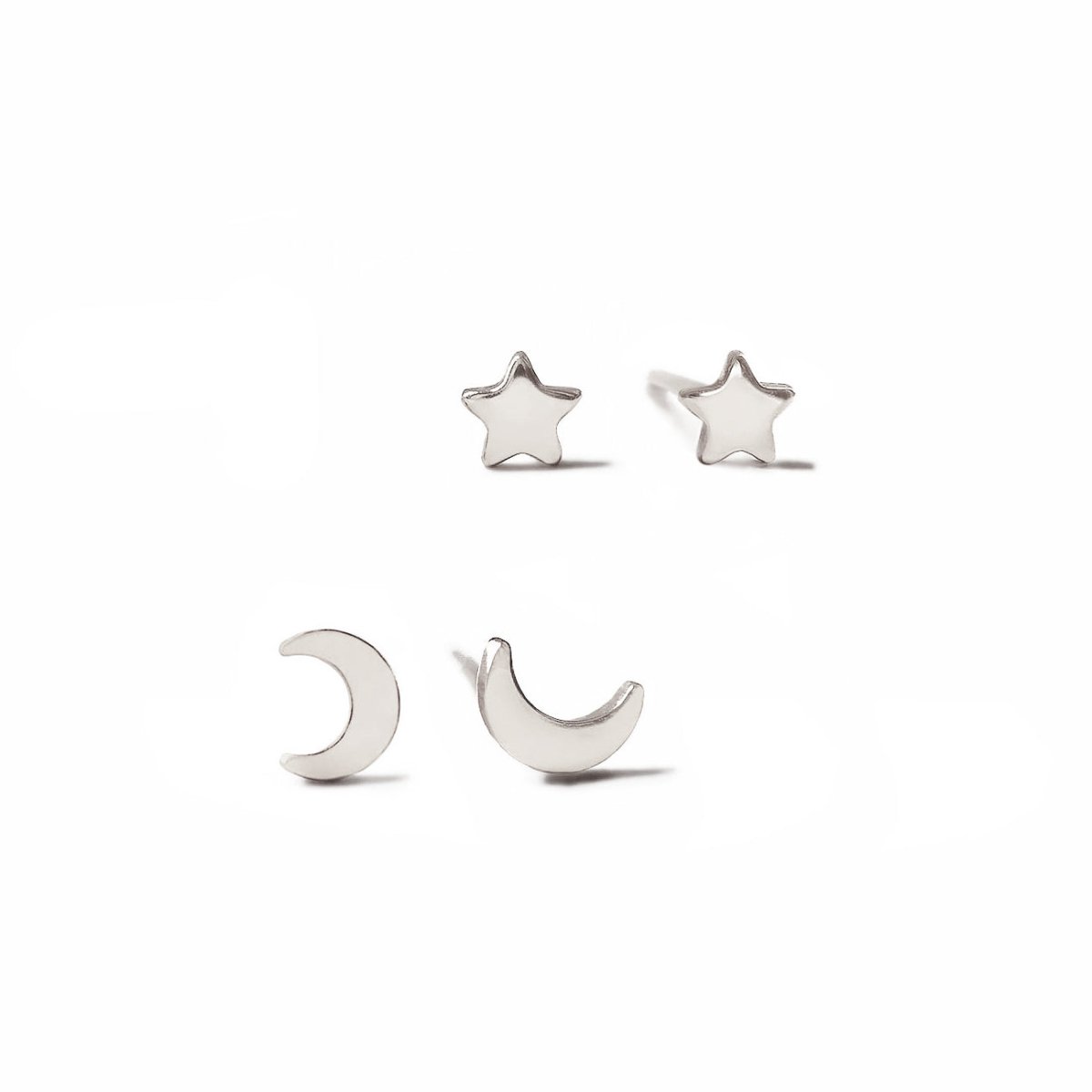 Sterling silver tiny moon and star stud earrings with polished crescent and star shapes, on a white background