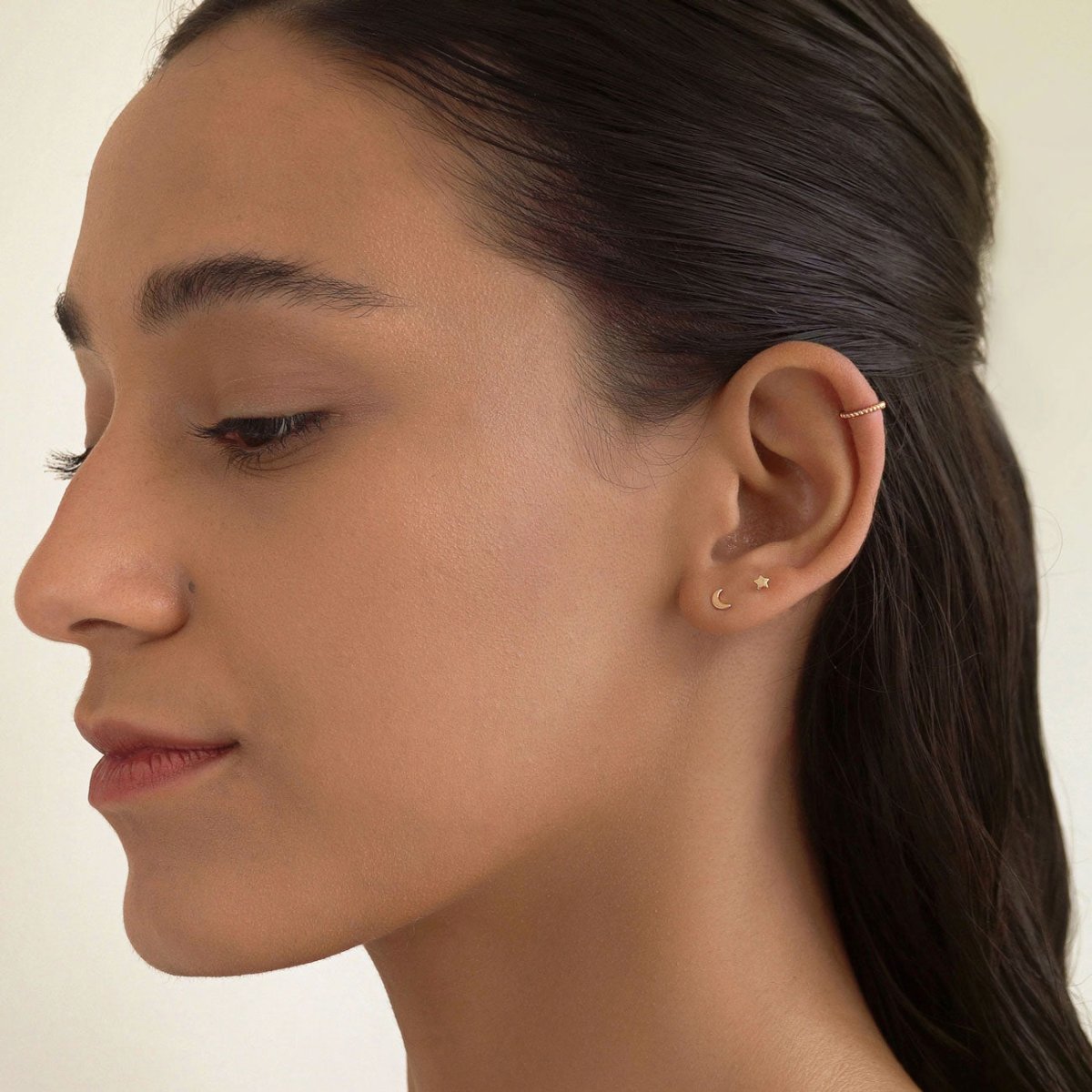 Rose gold vermeil beaded ear cuff styled in an ear stack, shown on a model's ear