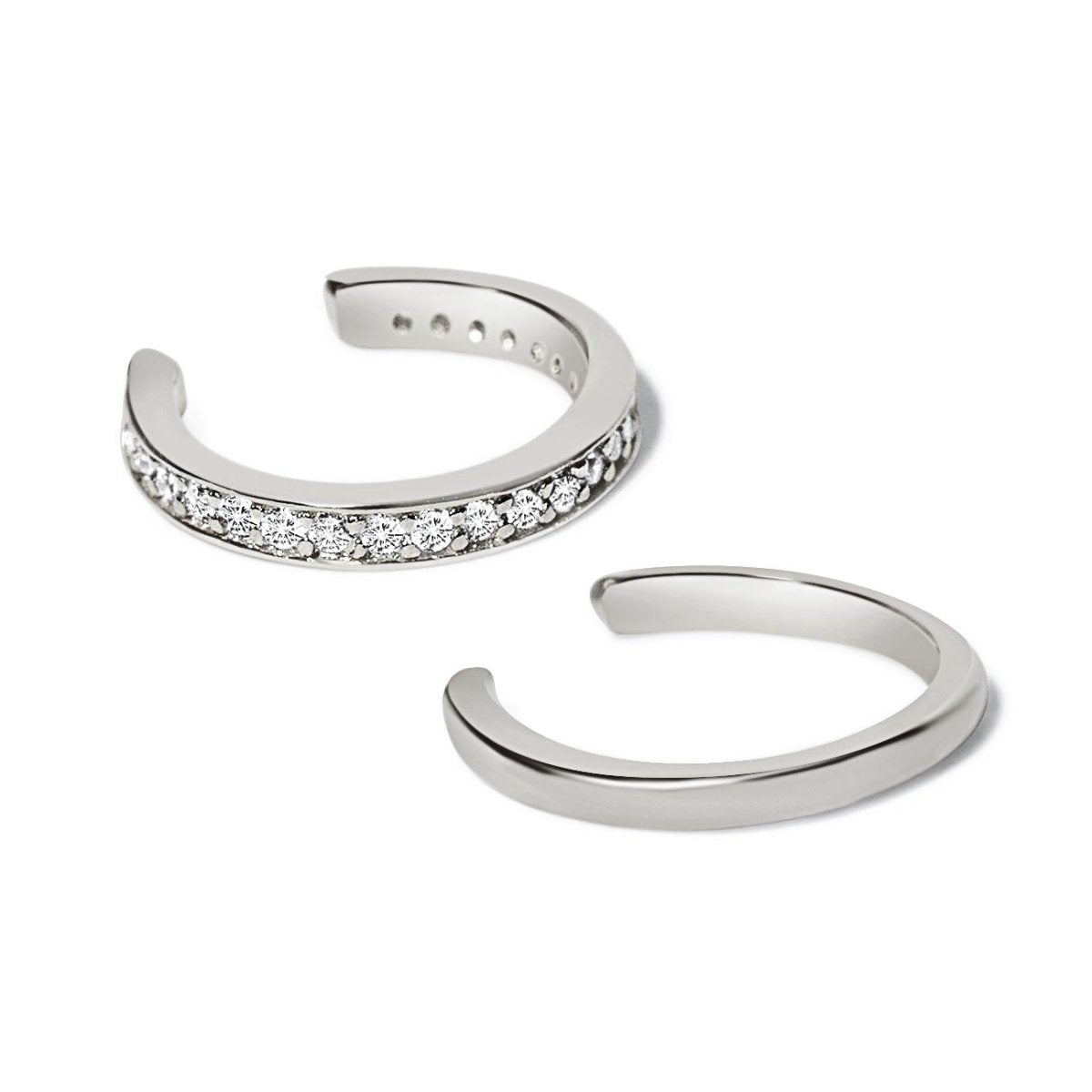 Sterling silver ear cuff set, one pavé with clear stones and one plain band, on a white background
