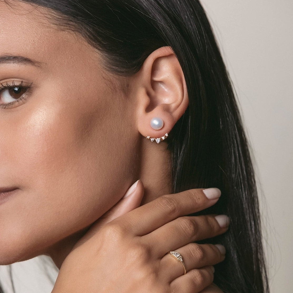 Rose gold vermeil pearl ear jacket studs with a crystal fan, shown on a model's ear