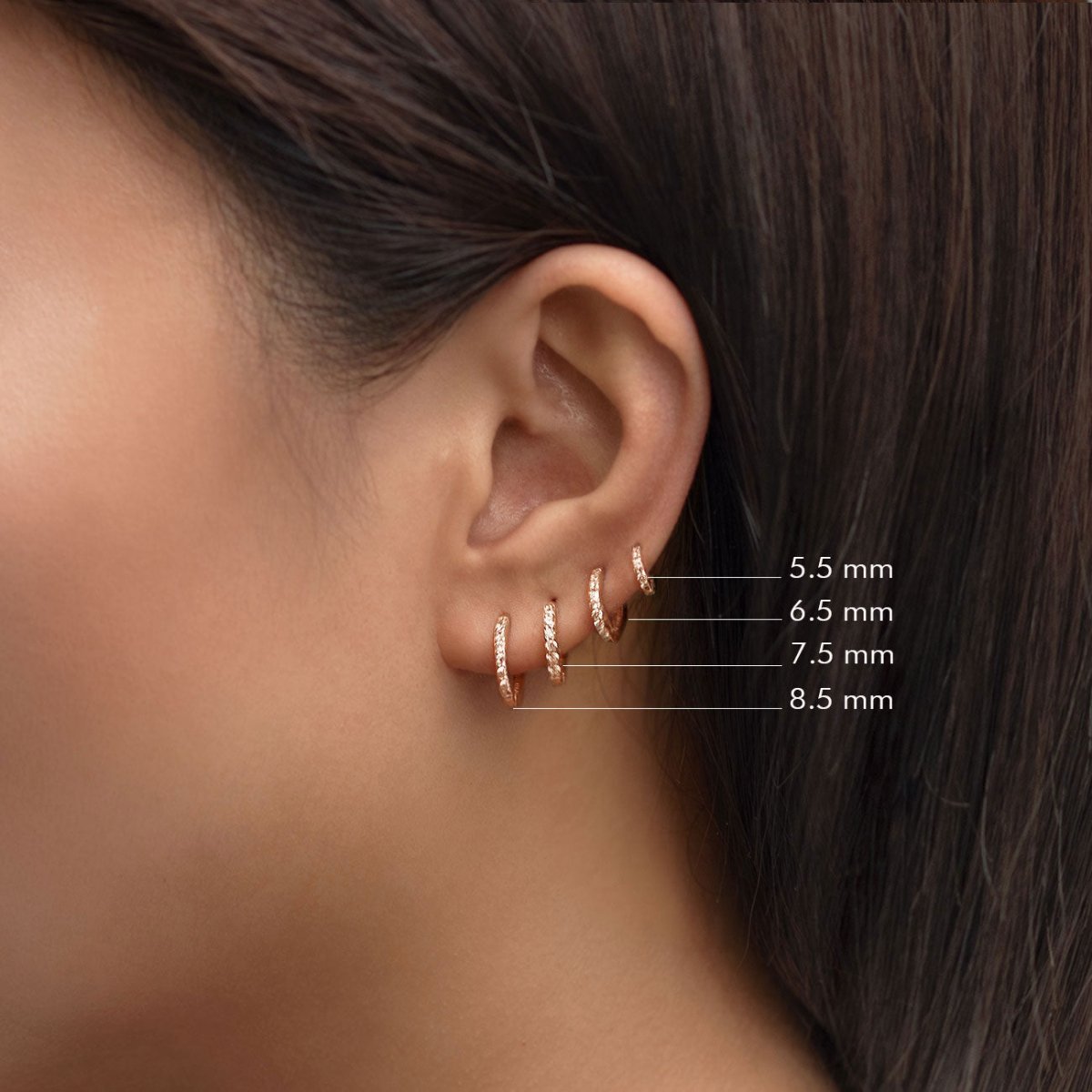 Rose gold vermeil pavé huggie hoops size guide, 5.5 to 8.5 mm, shown on a model's ear