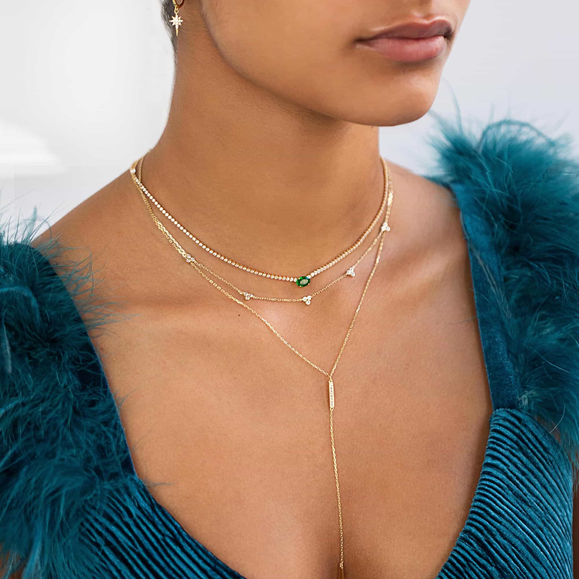 Gold vermeil clover bar lariat layered necklaces with clear stones, shown on a model's neckline