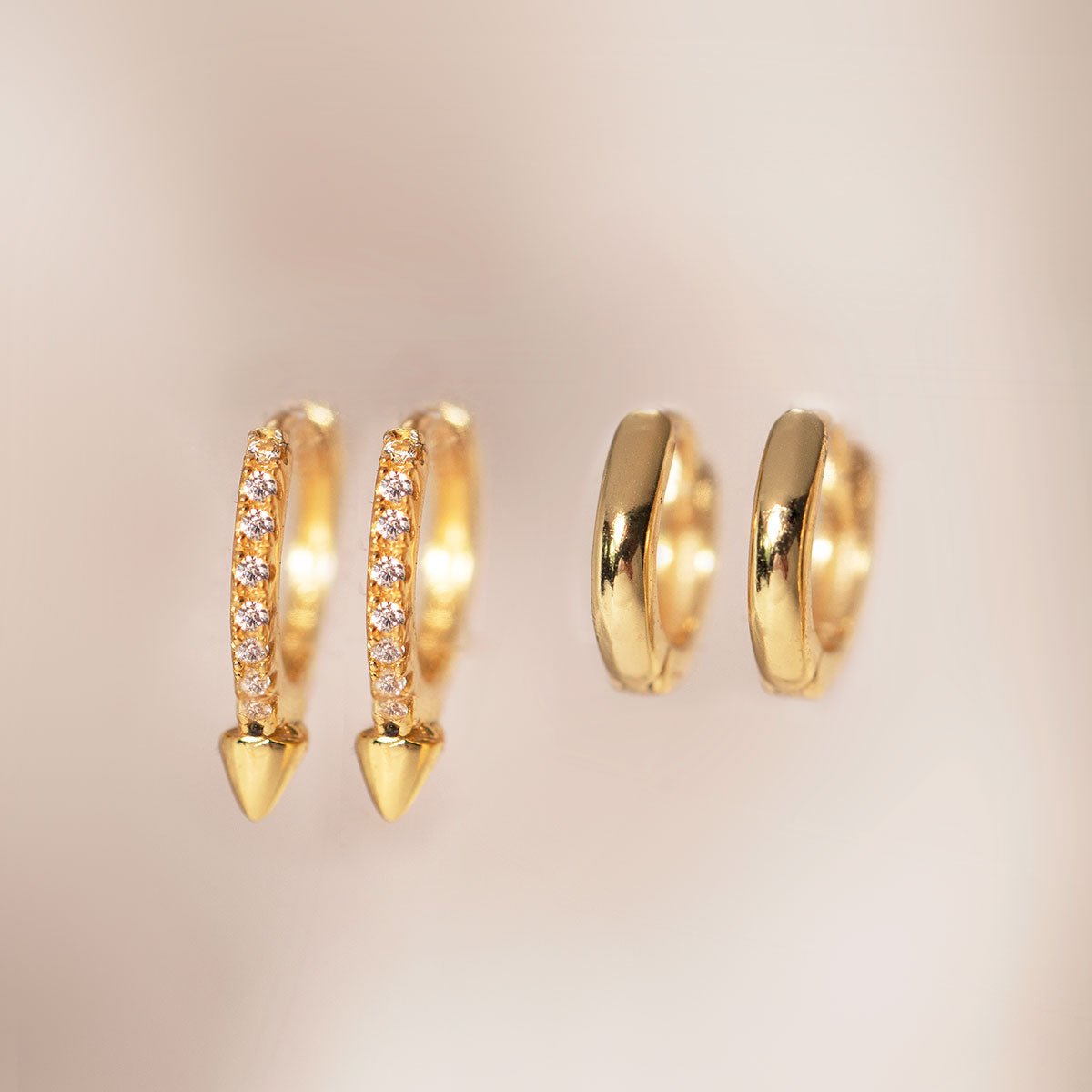 Gold vermeil pavé spike huggie hoops shown beside plain gold huggies, close-up detail