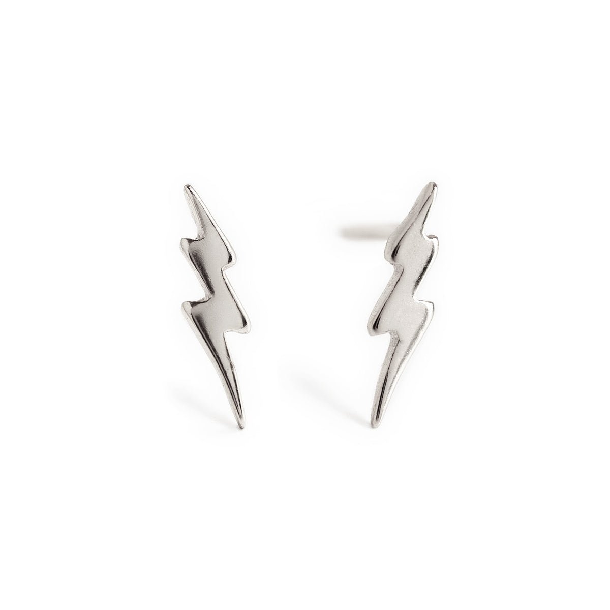 Sterling silver tiny lightning bolt stud earrings shown as a pair, close-up detail on a white background