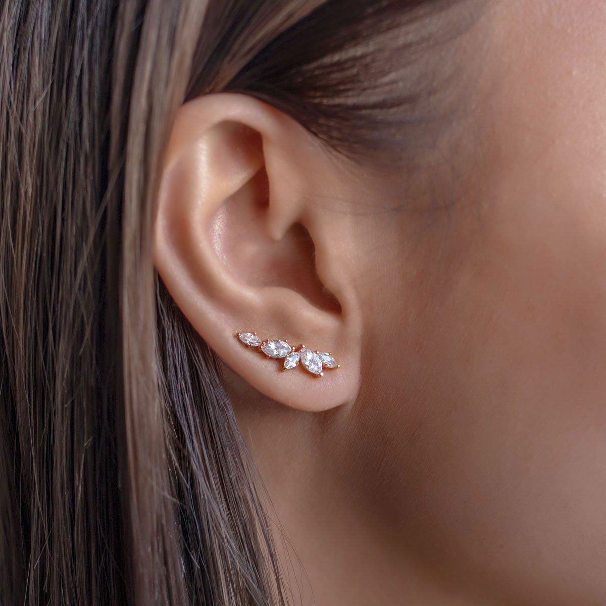 Rose gold vermeil marquise ear climber with white zirconia, close-up on a model's lobe