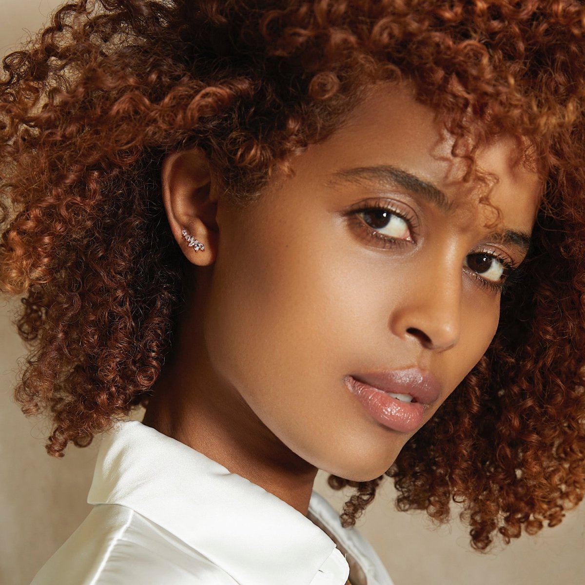 Rose gold vermeil marquise ear climber with white zirconia, shown on a model's ear