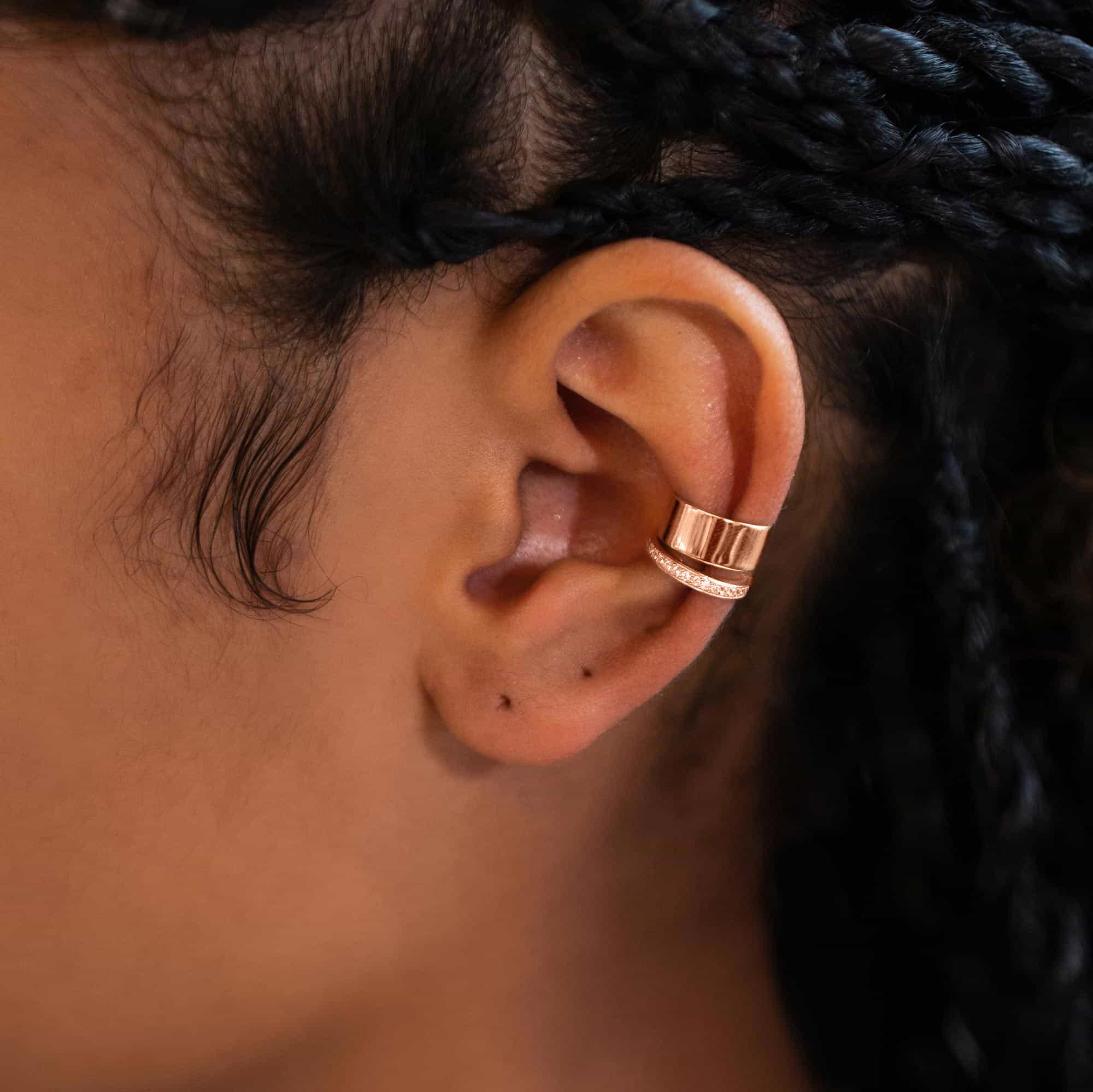 Rose gold vermeil ear cuff set, plain wide band and zirconia pavé band, shown on a model's ear