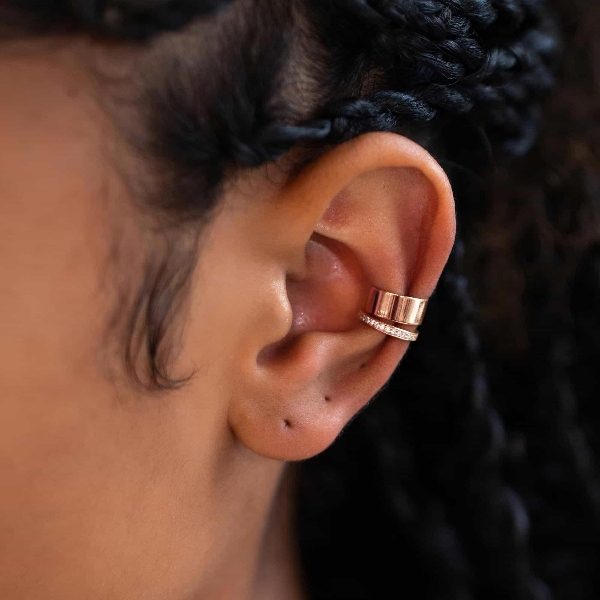 Rose gold vermeil plain and pave white zirconia ear cuffs stacked on a model's upper ear