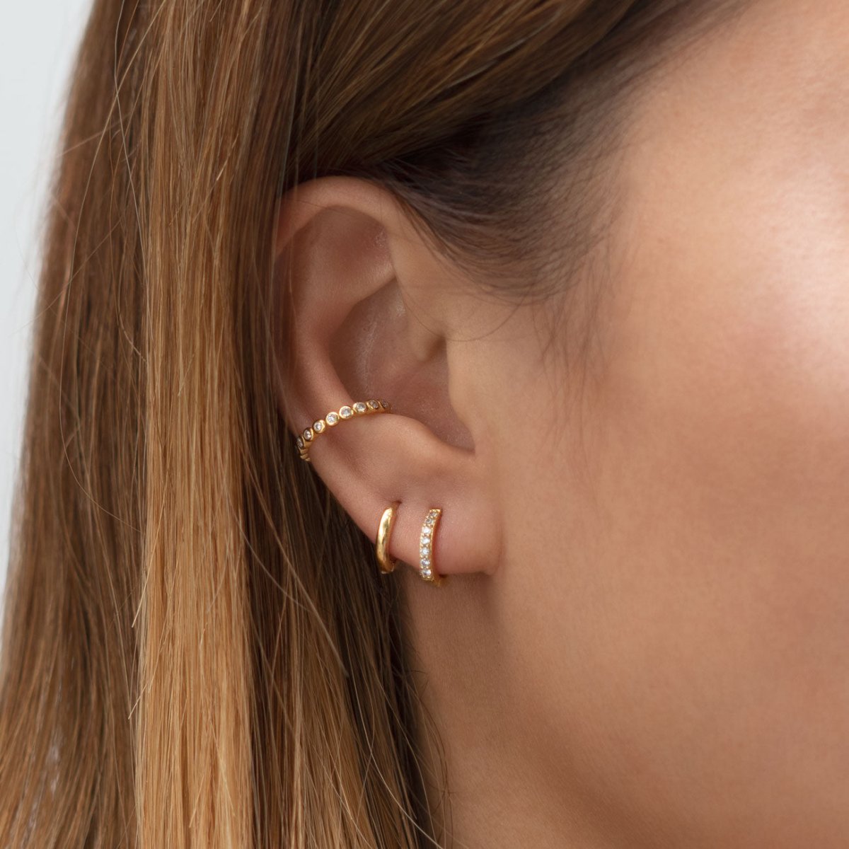 caption: Model has average earlobes, wearing 7.5mm on first hole