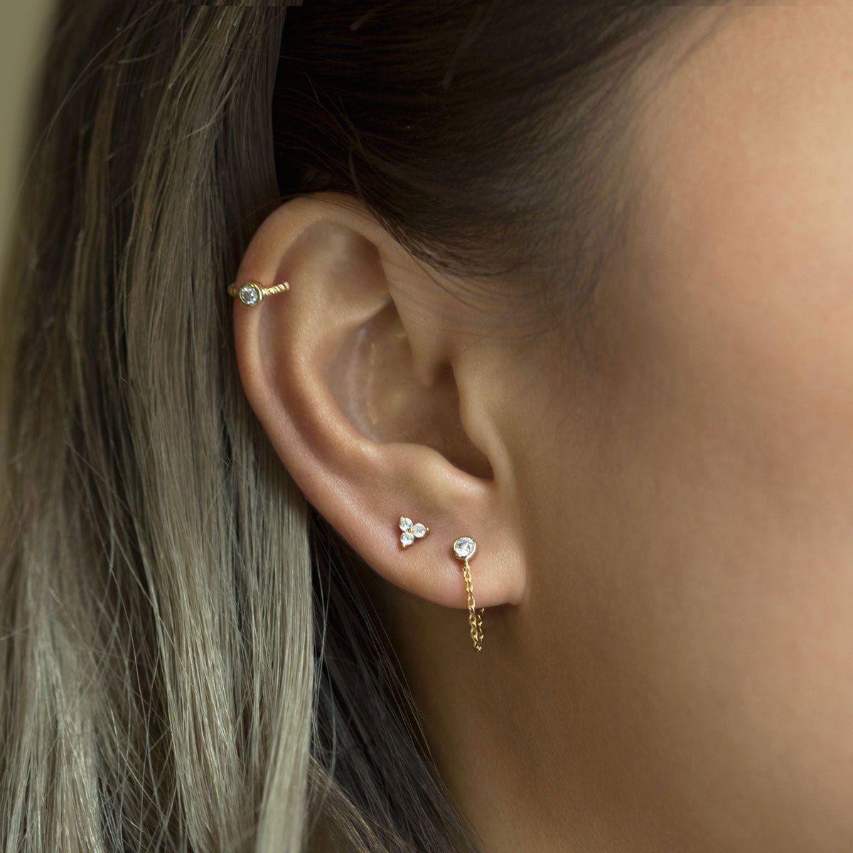 Gold vermeil bezel chain stud earring shown on a model's lobe, side profile view