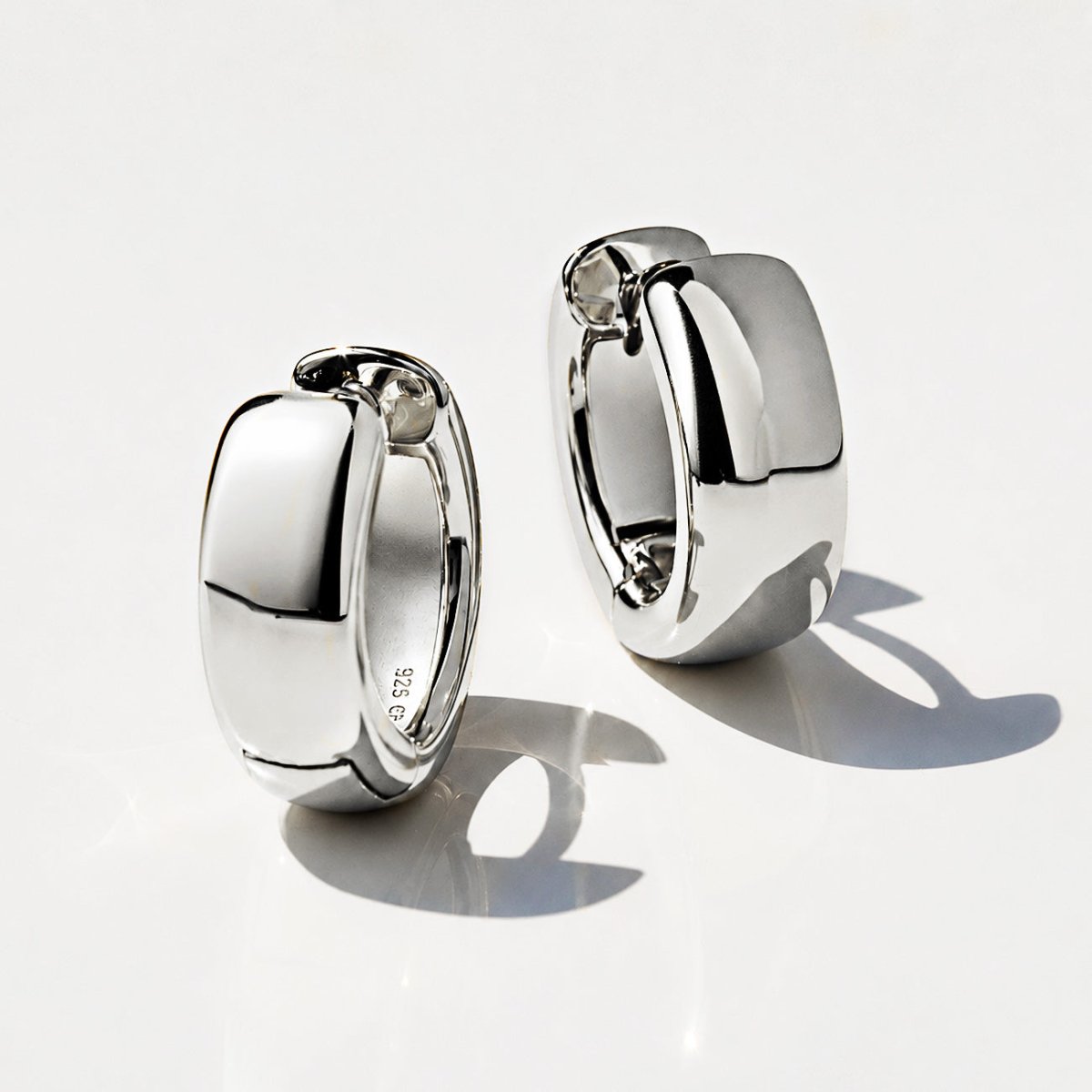 Sterling silver chunky boyfriend mini hoop earrings, close-up detail