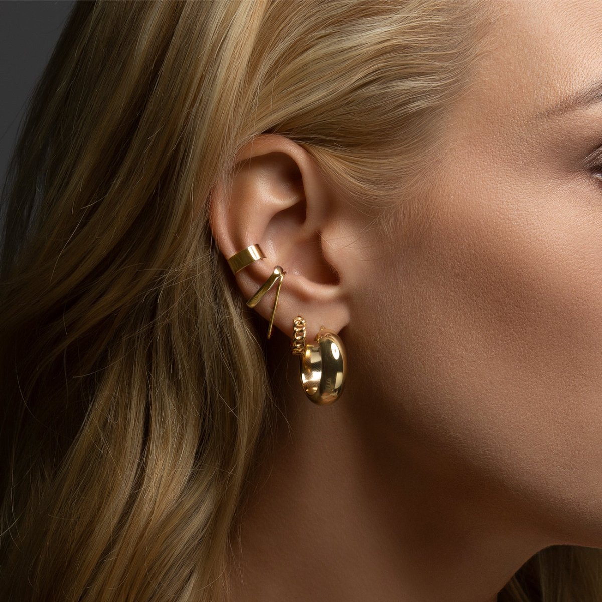 Gold vermeil bold suspender ear cuff styled in an ear stack on a model's ear