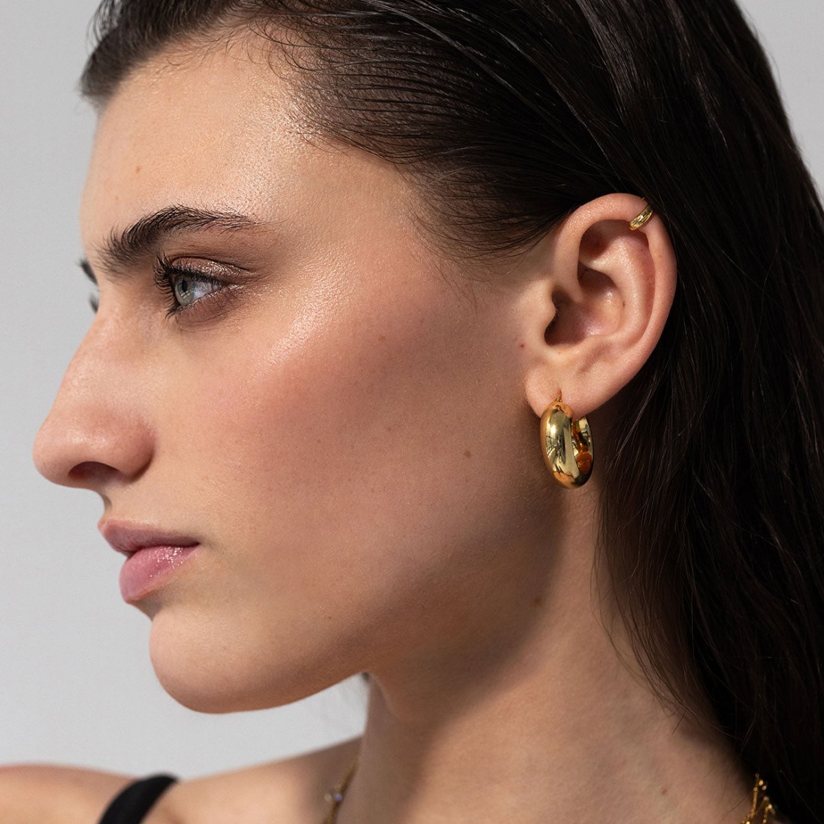 Gold vermeil chunky hoop and ear cuff styled in an ear stack on a model