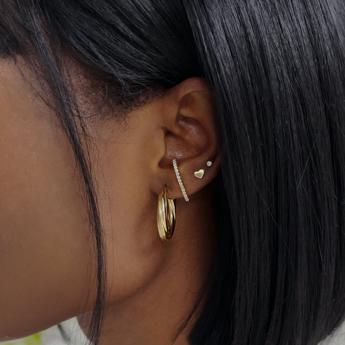 Gold vermeil pavé suspender earring with white zirconia, shown styled on a model's lobe