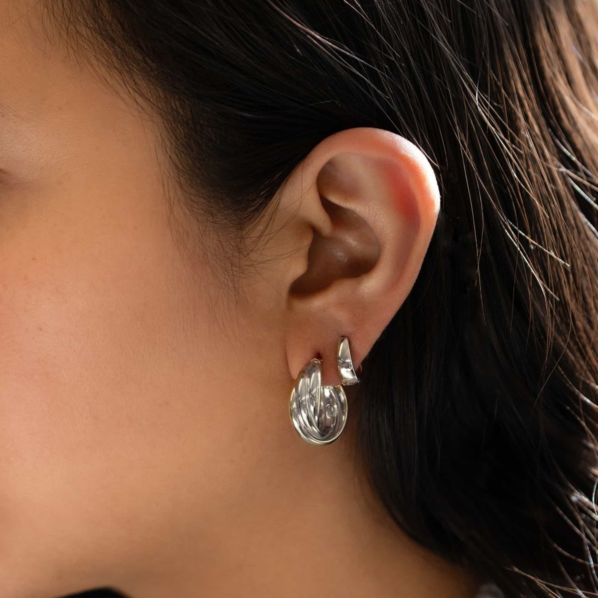 Sterling silver chunky twisted-rope hoop earring, shown on a model's lobe