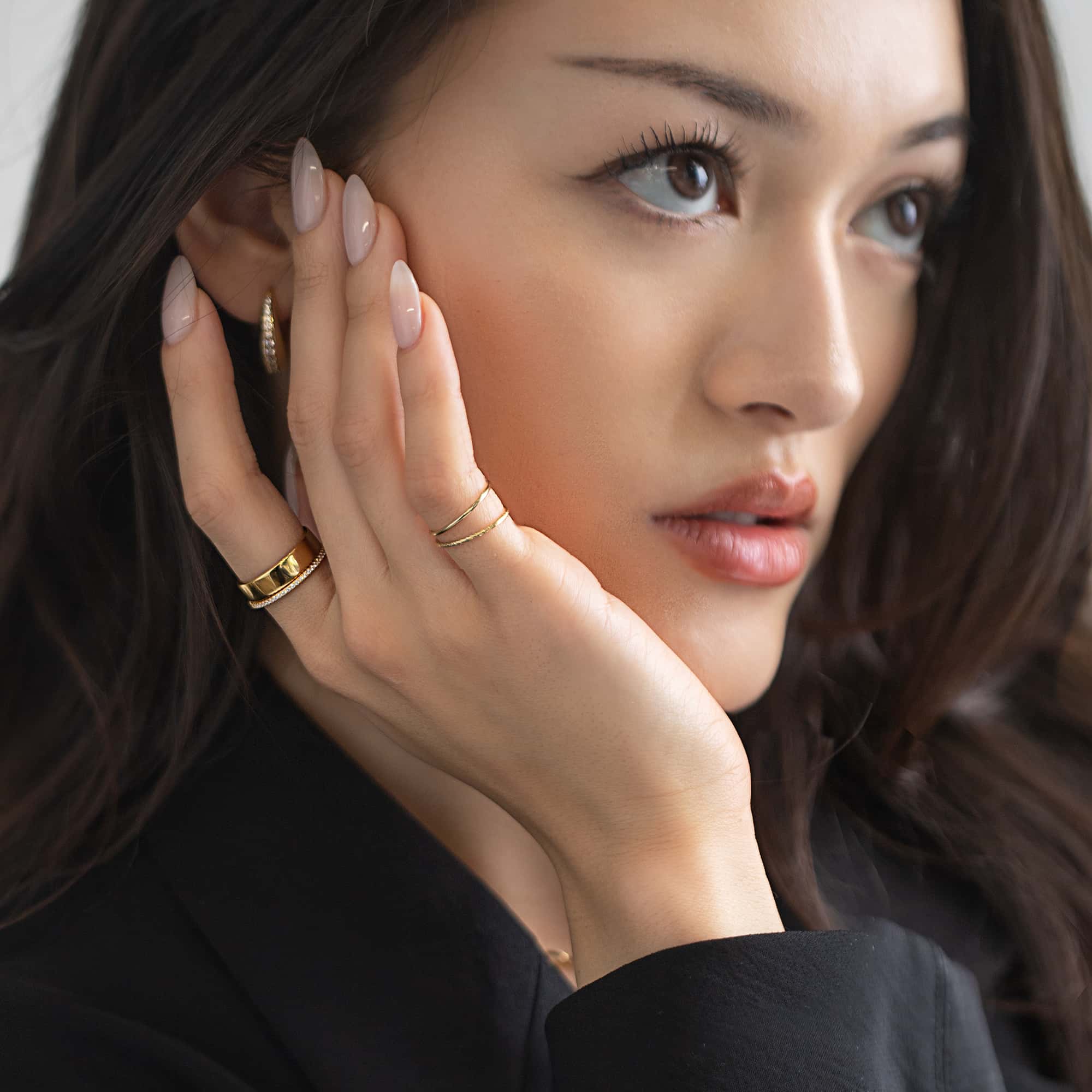 Gold-filled thin stacking ring set shown on a model's finger