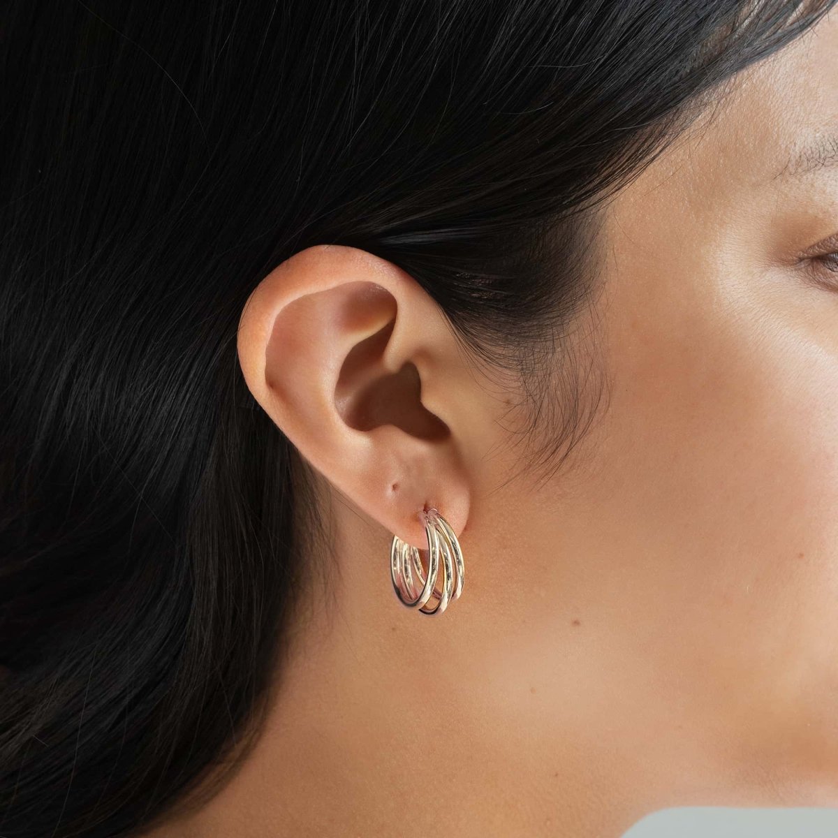 Sterling silver triple hoop earring shown on a model's lobe