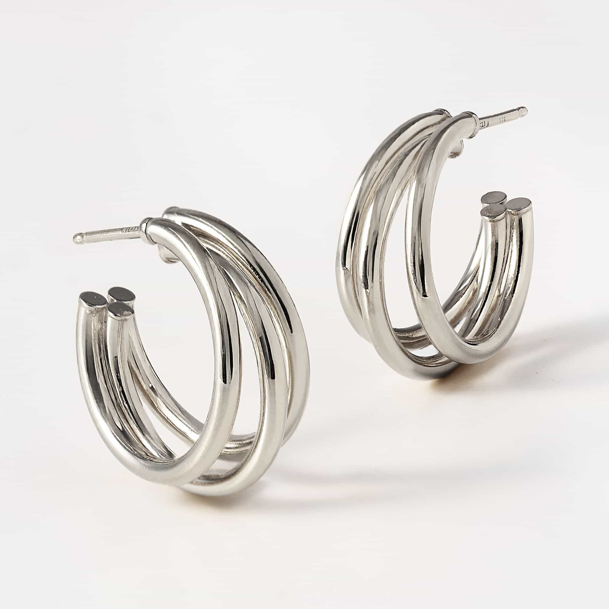 Sterling silver triple-row open hoop earrings shown at an angle on a white background