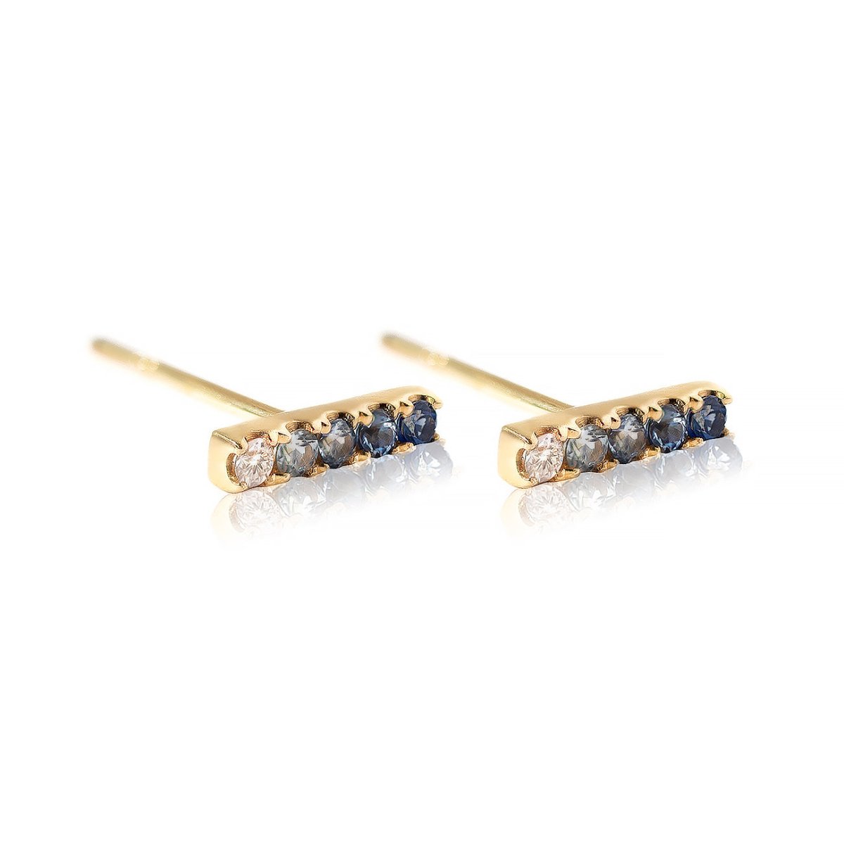 Pair of 14K gold bar studs with ombre clear and blue sapphire stones, on a white background