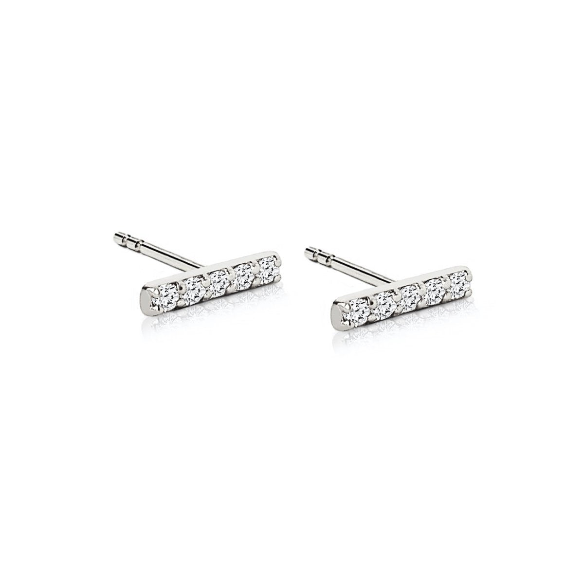 Pair of 14K white gold bar studs each set with five round diamonds, on a white background