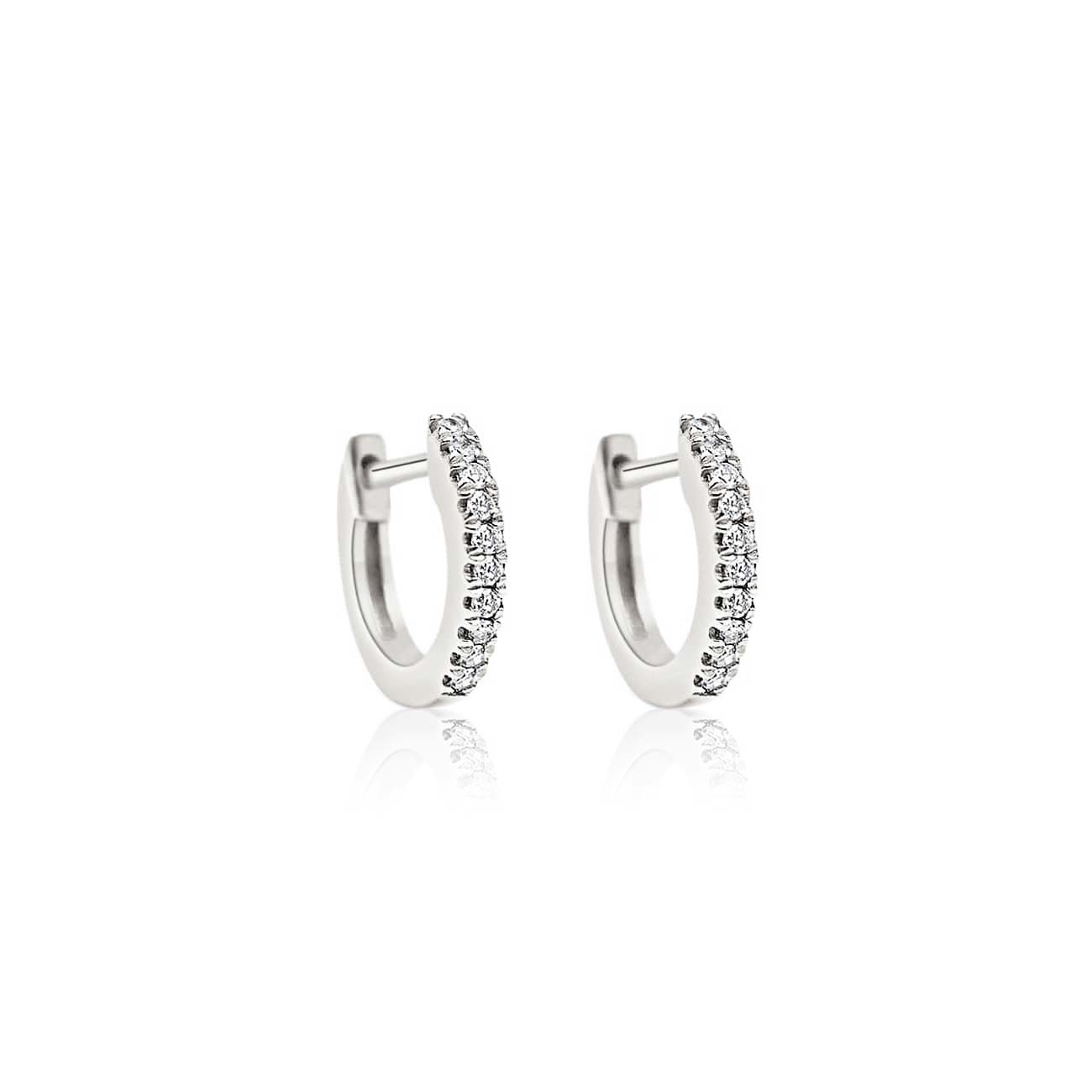 Pair of 14K white gold pavé diamond huggie hoops with a hinged closure, on a white background