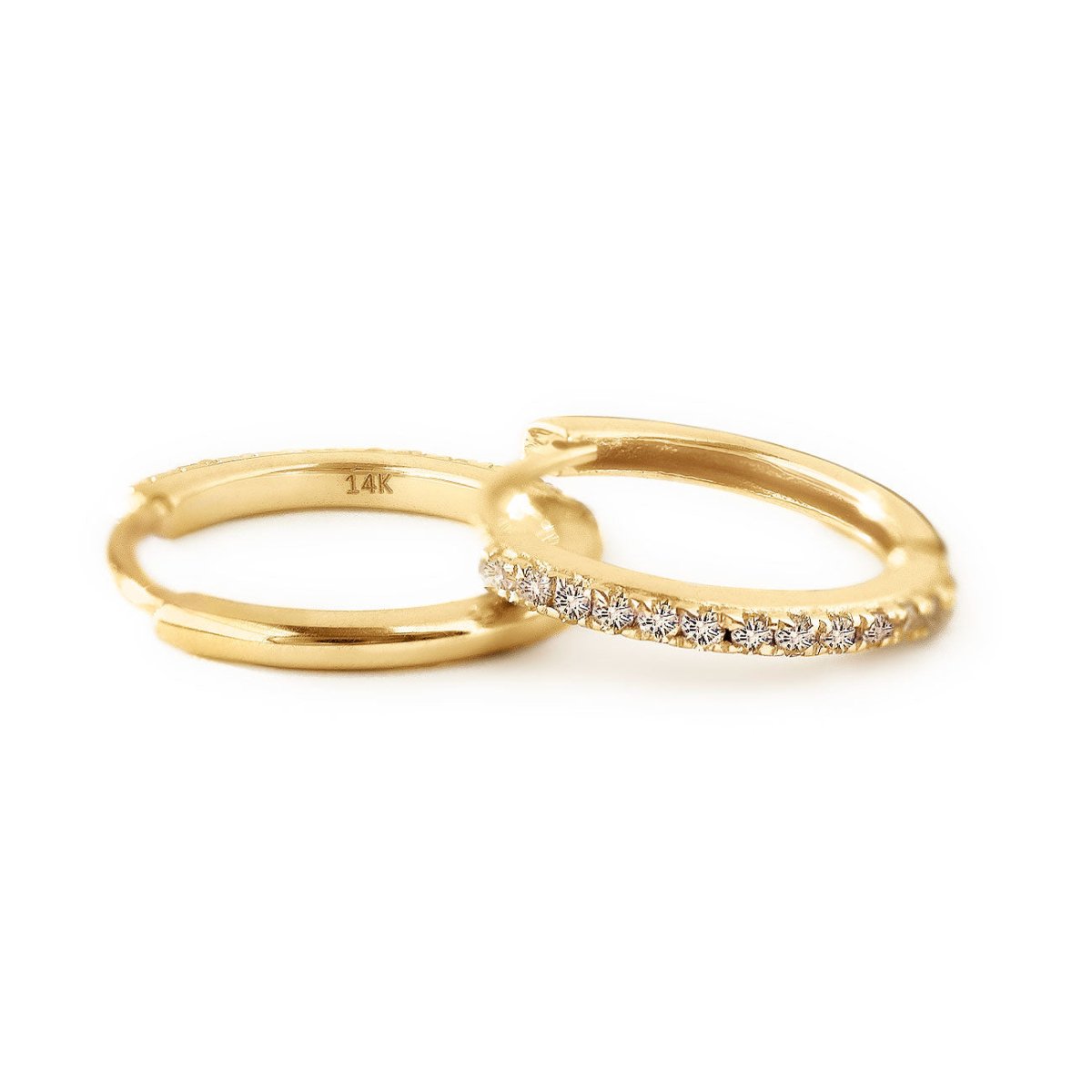 14K gold diamond huggie hoops showing pave row and 14K stamp, on a white background