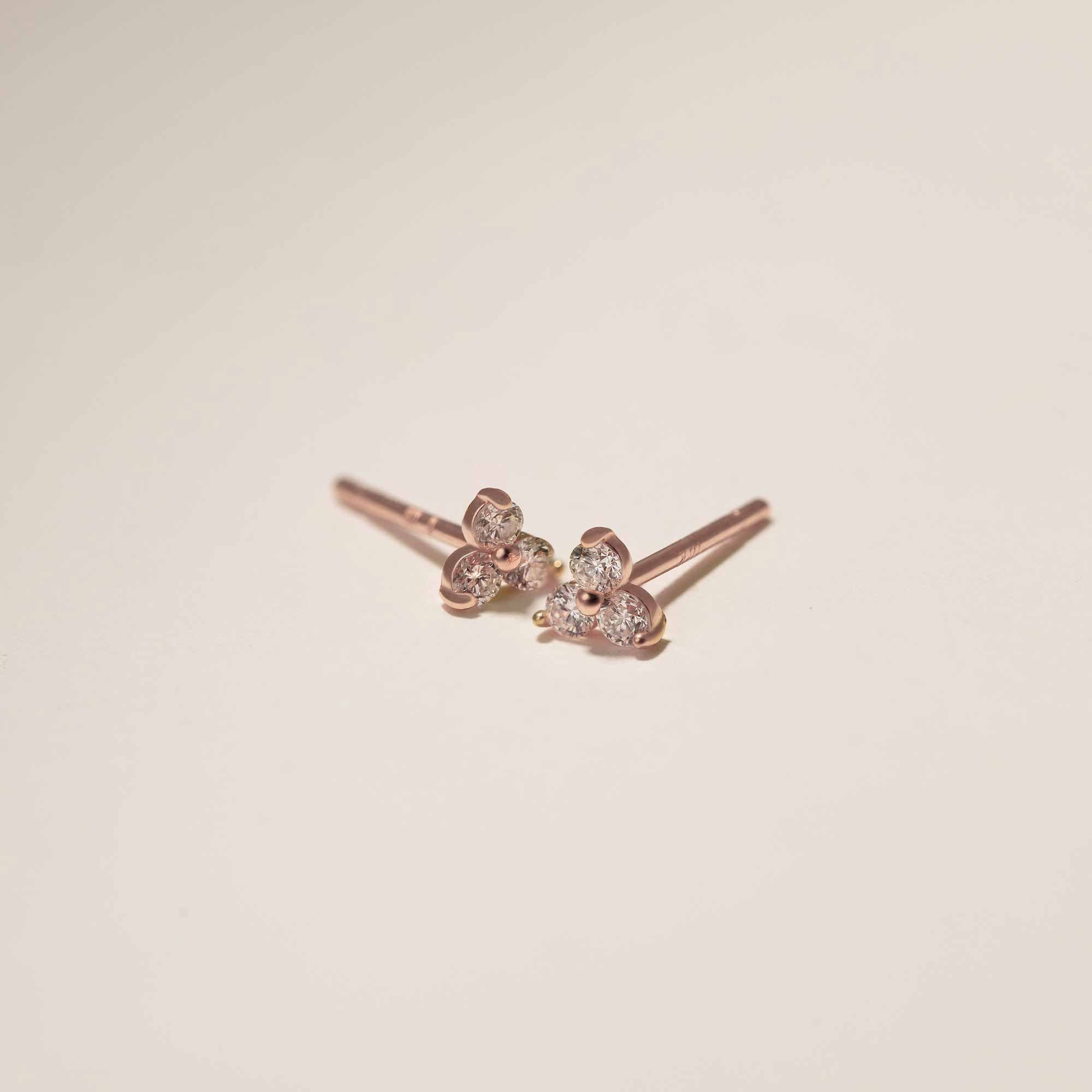 Close up of earring featuring 14K Pave Clover Rose Gold Stud Earrings