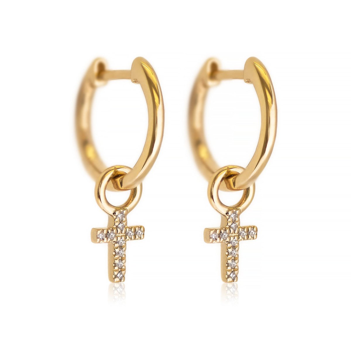 Pair of 14K gold huggie hoops with dangling pave diamond cross charms, on a white background