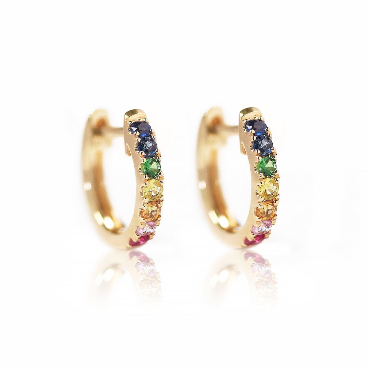 14K gold pavé huggie hoops set with rainbow blue, green, yellow and pink stones, on a white background