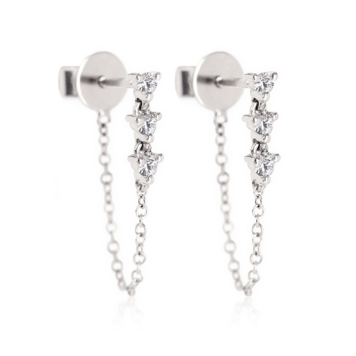 Pair of 14K white gold diamond drop chain stud earrings with three round stones, on a white background