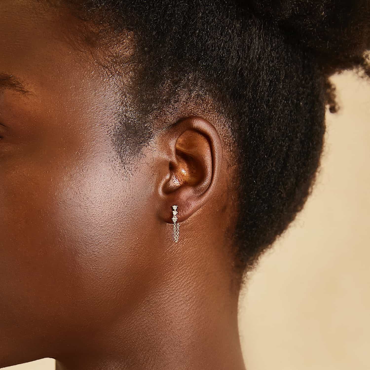 14K white gold diamond drop chain earrings, close-up detail shown on a model's ear