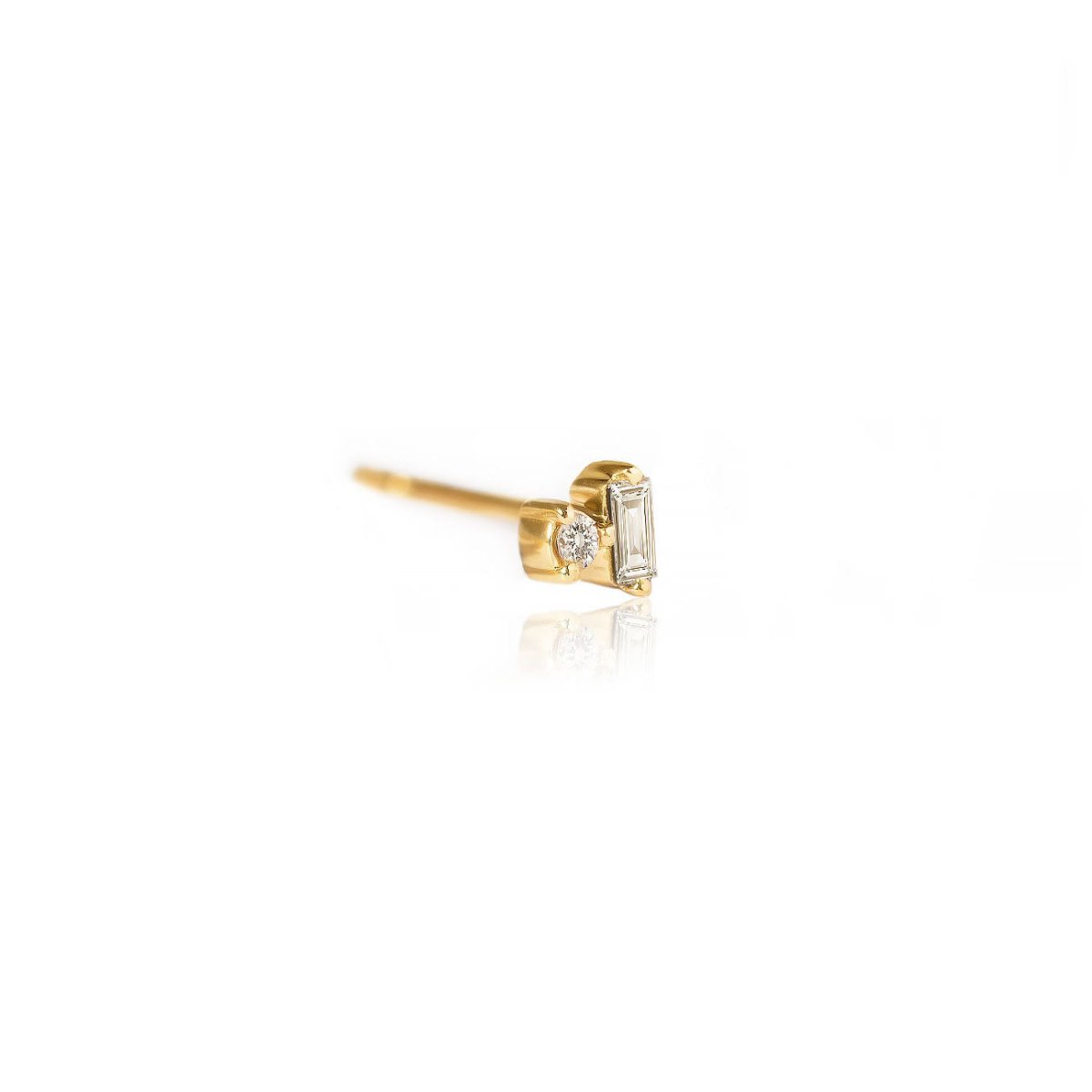 14K gold stud with a baguette and round diamond, side view on a white background