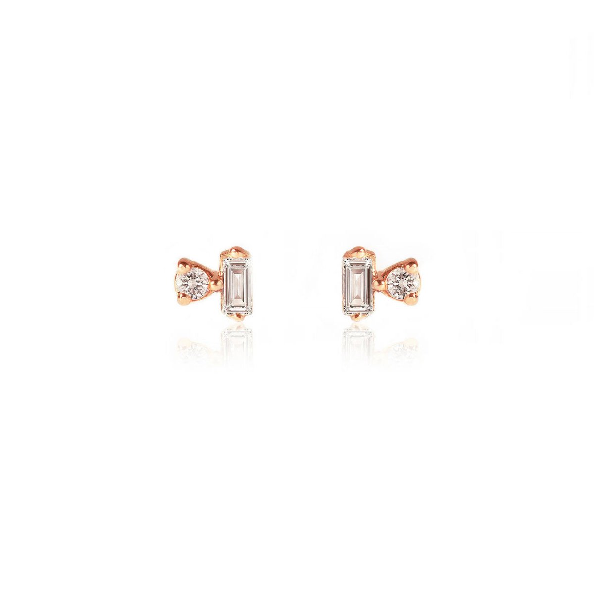 Pair of 14K rose gold baguette and round diamond duet studs, on a white background