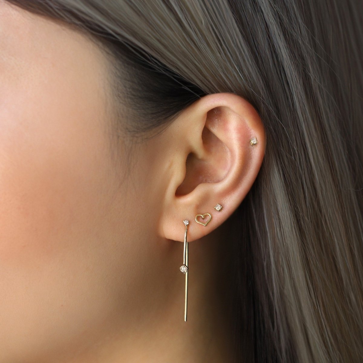 14K gold diamond threader earring shown threaded through a model's lobe